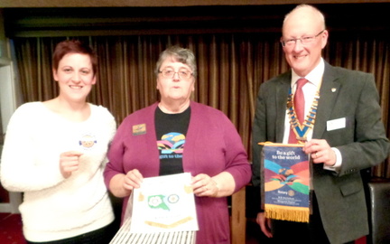 DG Margaret Taylor exchanging banners with John Balshaw and Amy Connors
